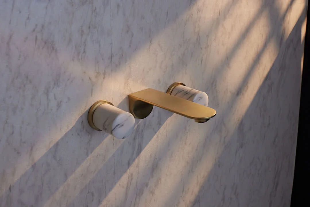 Brass basin mixer on a marble counter — original finish