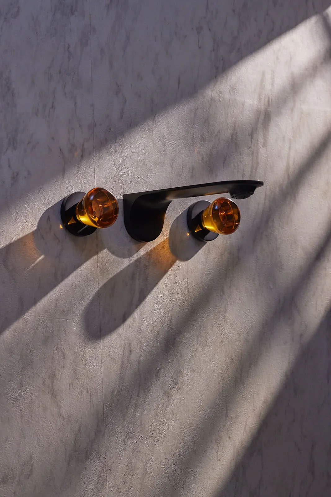 Showroom detail — stone, brass and light